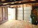 Unfinished garage with overhead door and side door at 4840 Hillside Ave, Indianapolis, IN 46205