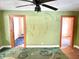 Hallway with green walls, patterned carpet, and doors to other rooms at 4840 Hillside Ave, Indianapolis, IN 46205