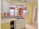 Kitchen features a double sink and view into dining area at 4840 Hillside Ave, Indianapolis, IN 46205