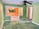 Living room with green walls, patterned carpet, and ceiling fan at 4840 Hillside Ave, Indianapolis, IN 46205