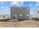 Back exterior of newly constructed home with gray siding and a sliding glass door at 5144 Rolling Meadow Blvd, Indianapolis, IN 46237