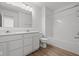 Bathroom with double vanity, large mirror, and shower/tub combo with white tile surround at 5144 Rolling Meadow Blvd, Indianapolis, IN 46237