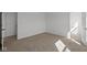Bedroom featuring neutral carpeting with a door to the closet and a second doorway at 5144 Rolling Meadow Blvd, Indianapolis, IN 46237