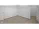 This bedroom features neutral carpeting and a walk-in closet for storage at 5144 Rolling Meadow Blvd, Indianapolis, IN 46237