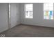 A bedroom with neutral carpet and two windows, showing the bright and airy atmosphere at 5144 Rolling Meadow Blvd, Indianapolis, IN 46237