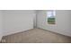 Bedroom showcasing neutral carpeting and a window that looks out to the neighborhood at 5144 Rolling Meadow Blvd, Indianapolis, IN 46237