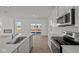 Open kitchen showcasing white cabinets, a center island, and stainless steel appliances at 5144 Rolling Meadow Blvd, Indianapolis, IN 46237