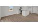 Bright kitchen with white cabinets, stainless appliances, and modern wood-look flooring at 5144 Rolling Meadow Blvd, Indianapolis, IN 46237