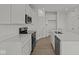 Modern kitchen featuring white cabinets, stainless steel appliances, and hardwood floors at 5144 Rolling Meadow Blvd, Indianapolis, IN 46237