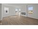 Bright living room featuring hardwood floors, large windows, and a sleek fireplace at 5144 Rolling Meadow Blvd, Indianapolis, IN 46237