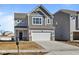 Attractive home with a two-car garage, light gray siding, and a classic design, complemented by a well-paved driveway at 5147 Rolling Meadow Blvd, Indianapolis, IN 46237