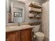 Modern bathroom with floating shelves and updated fixtures at 6265 Canterbury Dr, Zionsville, IN 46077