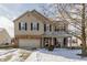 Two-story house with brick and siding, attached garage, and landscaping at 6265 Canterbury Dr, Zionsville, IN 46077