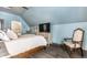 Elegant bedroom with vaulted ceilings, hardwood floors, and a comfortable sitting area at 634 E Vermont St, Indianapolis, IN 46202