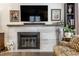 Modern fireplace with a stone surround and flat-screen TV above at 634 E Vermont St, Indianapolis, IN 46202