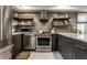 Modern kitchen featuring stainless steel appliances and wooden shelves at 634 E Vermont St, Indianapolis, IN 46202