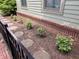 Landscaped area with rose bushes and brick pathway at 634 E Vermont St, Indianapolis, IN 46202