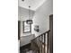 Modern staircase with dark wood railings and pendant lighting at 634 E Vermont St, Indianapolis, IN 46202