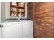 Functional laundry room with washer, dryer, and rustic wood accents at 653 Springdale Ln, Greenfield, IN 46140