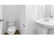 Powder room featuring a pedestal sink, a toilet and wood look flooring at 6752 W Buck Stone Dr, McCordsville, IN 46055