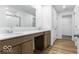 Modern bathroom featuring a double sink vanity, large mirror, and separate shower at 6752 W Buck Stone Dr, McCordsville, IN 46055