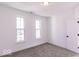 Bright bedroom with gray carpeting and two large windows at 6752 W Buck Stone Dr, McCordsville, IN 46055