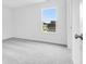 A carpeted bedroom with a large window that lets in natural light at 6752 W Buck Stone Dr, McCordsville, IN 46055