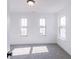 Well-lit bedroom with three windows and gray carpeting at 6752 W Buck Stone Dr, McCordsville, IN 46055