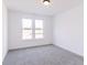 Bright bedroom with gray carpeting and two large windows at 6752 W Buck Stone Dr, McCordsville, IN 46055