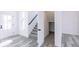 Open entryway with stairs leading upstairs and grey flooring at 6752 W Buck Stone Dr, McCordsville, IN 46055