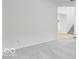 Hallway with grey carpet leading to the staircase at 6752 W Buck Stone Dr, McCordsville, IN 46055