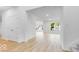 Open hallway view features beautiful wood look flooring and natural light at 6752 W Buck Stone Dr, McCordsville, IN 46055