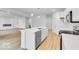 Spacious kitchen with island featuring a stainless steel dishwasher and a view of the living room at 6752 W Buck Stone Dr, McCordsville, IN 46055