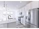 Modern kitchen with white cabinets, stainless steel appliances, and a large island at 6752 W Buck Stone Dr, McCordsville, IN 46055