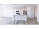 Modern kitchen with white cabinets, stainless steel appliances, and a large island at 6752 W Buck Stone Dr, McCordsville, IN 46055