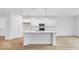 Modern white kitchen with large island, stainless steel appliances, and beautiful countertops at 6752 W Buck Stone Dr, McCordsville, IN 46055