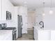 Modern kitchen with white cabinets and stainless steel appliances at 6752 W Buck Stone Dr, McCordsville, IN 46055
