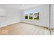 Bright room featuring windows and a glass door with wood floors and white walls at 6752 W Buck Stone Dr, McCordsville, IN 46055