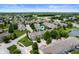 Overhead view of a townhome community with mature trees, manicured lawns, and a tranquil pond at 7042 Tyler Ln, Indianapolis, IN 46217