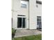 Back exterior with sliding glass doors that open to a concrete patio and well maintained siding at 7042 Tyler Ln, Indianapolis, IN 46217