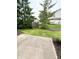 Backyard view featuring partial fencing with healthy grass and well-maintained plants and mulch at 7042 Tyler Ln, Indianapolis, IN 46217