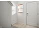 Bright entryway with tiled floor, white door, and window with blinds at 7042 Tyler Ln, Indianapolis, IN 46217