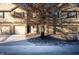 Tan two-story townhome with attached garage and snow-covered driveway at 7042 Tyler Ln, Indianapolis, IN 46217
