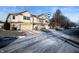 Two-story townhome with attached garage and snowy driveway at 7042 Tyler Ln, Indianapolis, IN 46217
