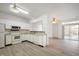 White kitchen boasts granite countertops and stainless steel appliances at 7042 Tyler Ln, Indianapolis, IN 46217
