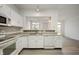 White kitchen with granite countertops and stainless steel appliances at 7042 Tyler Ln, Indianapolis, IN 46217