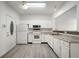White kitchen features granite countertops and stainless steel appliances at 7042 Tyler Ln, Indianapolis, IN 46217