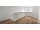 Upstairs hallway with neutral carpeting and wall-mounted lighting at 7042 Tyler Ln, Indianapolis, IN 46217