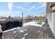 Snow-covered deck with seating area and grill, offering outdoor space at 7816 Delbrook Dr, Indianapolis, IN 46260