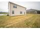 Backyard view showcasing the home's exterior, patio, and spacious lawn area at 7824 Magnolia St, New Palestine, IN 46163